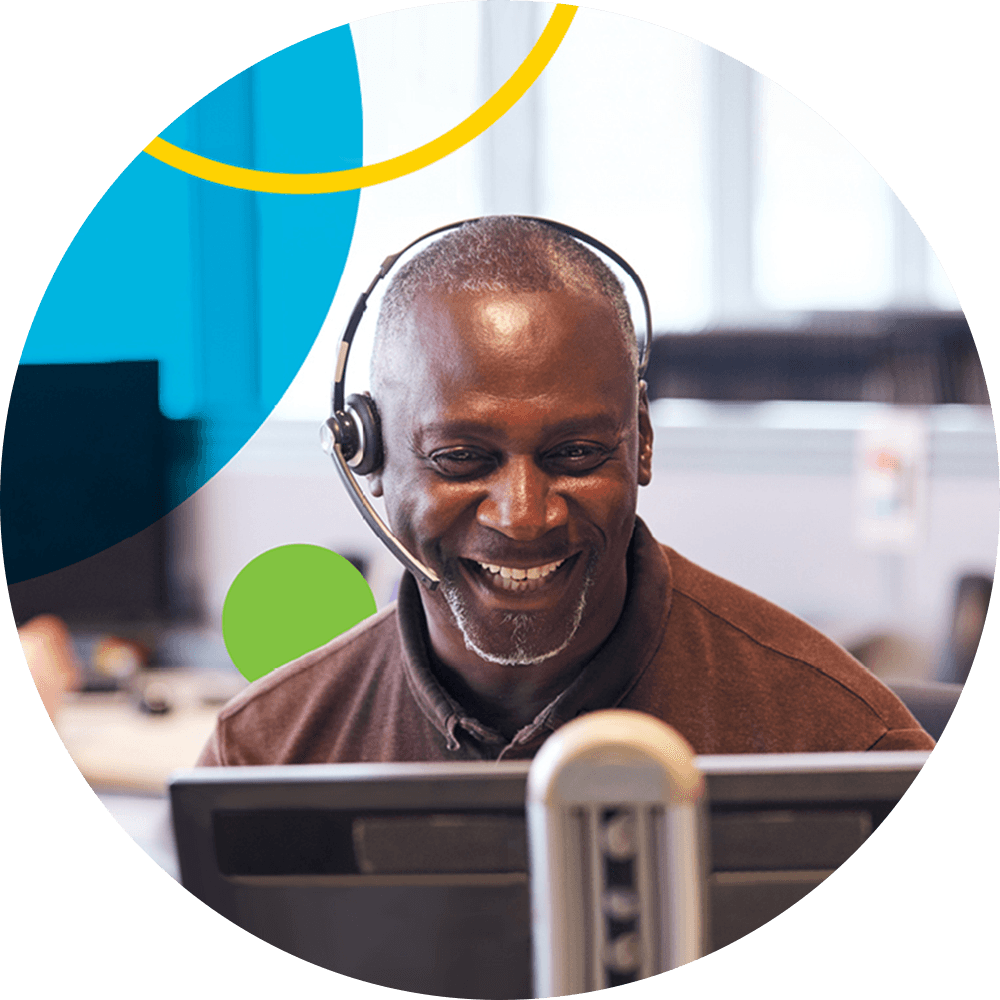 Smiling businessman answering a customer call